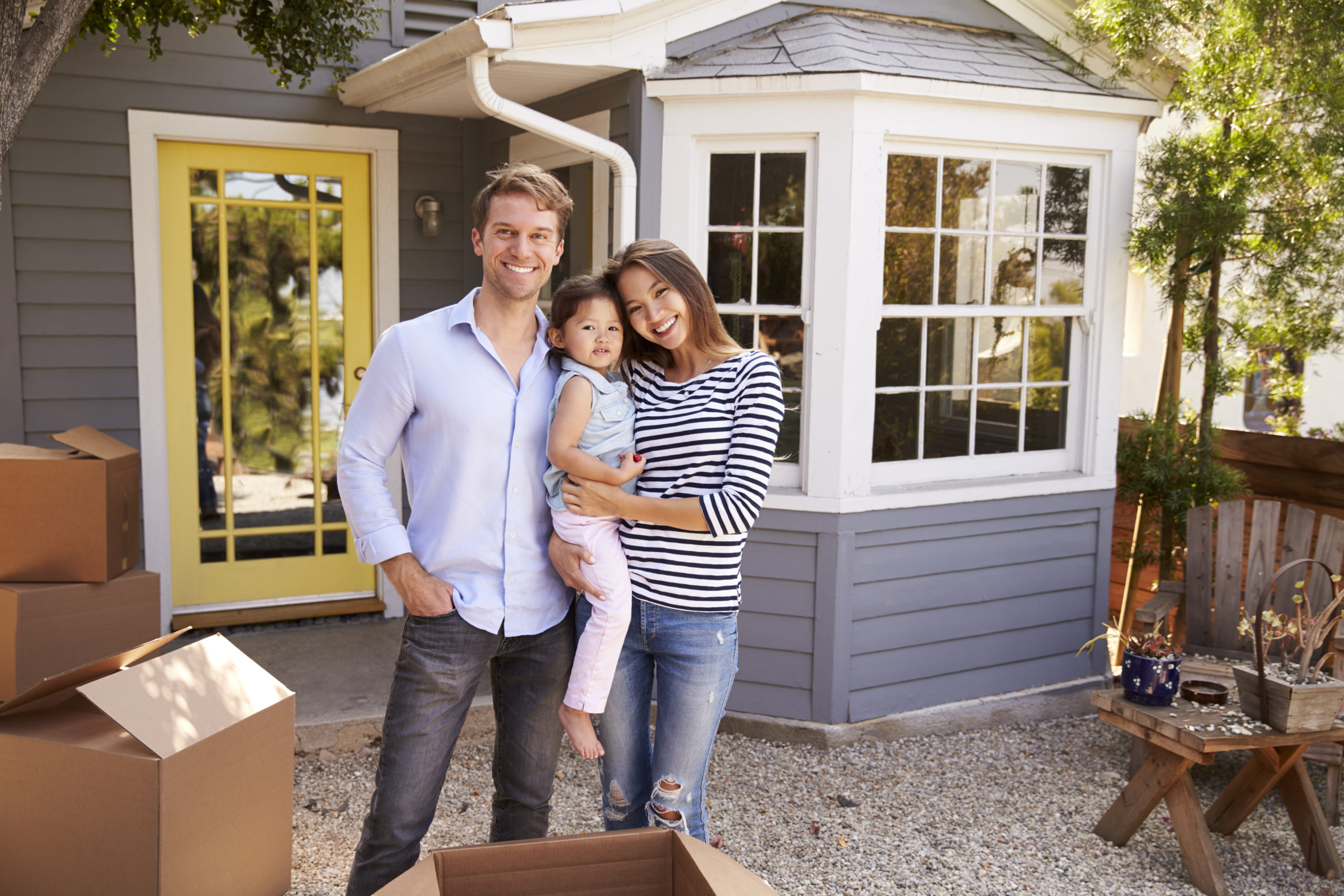 Portrait,Of,Excited,Family,Standing,Outside,New,Home